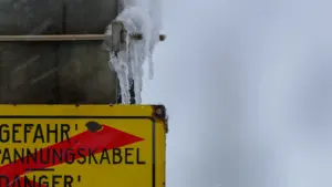 Dzeltena bīstamības brīdinājuma zīme ar lāstekām ziemas laikapstākļu laikā, tuvu skats.